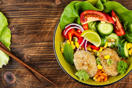 Vegan salad, vegetable buddha bowl lunch with fish meatballs or fried fish cutlets.の写真素材