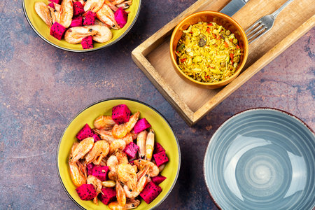 Shellfish, spicy roasted shrimps garnished with ripe pitaya or pitahaya.の写真素材