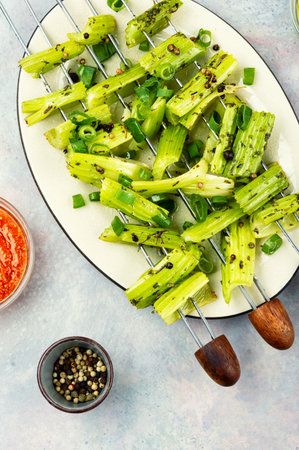 Grilled celery stalks on skewers, vegetarian kebab.の写真素材