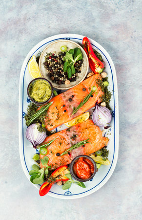 Two uncooked, raw salmon fillets. Spices, sauces and herbsの写真素材