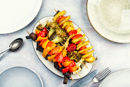 Grilled skewers of various vegetables, tomato, bell pepper, mushrooms, zucchini and broccoli. Overhead view.の写真素材