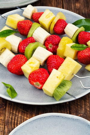 A refreshing fruit skewer with strawberries, banana and pineapple. Assorted fruit skewers.の写真素材