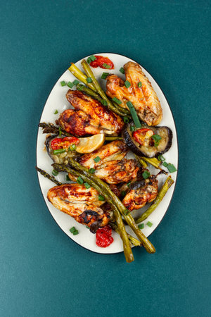 Delicious fried chicken wings with green asparagus and eggplant, grilled chicken wings. Flat lay.の写真素材