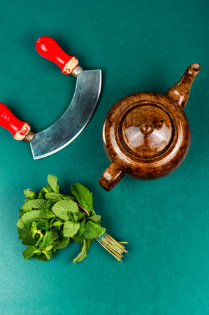 Herbal tea with various herbs. Herbal tea with mint thyme. The process of pouring tea.の写真素材