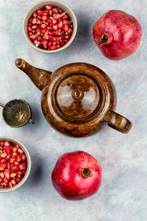 Freshly brewed fruit and herbal tea with fresh pomegranate seeds. Flat lay.の写真素材
