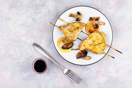 Rare roasted tuna steak on skewers, BBQ. Grilled fish kebabs with mushrooms.の写真素材