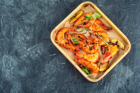 Fried langoustines with lemon slices, roasted king prawns or tiger shrimps. Space for text.の写真素材