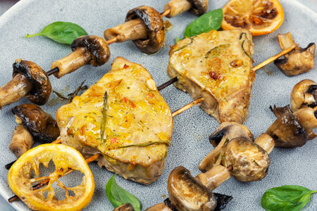 Grilled tuna fish served on plate with mushrooms. Freshly cooked roasted seafood dish on skewers.の写真素材