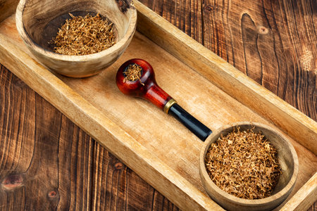 Elegant tobacco pipe filled with dried tobacco leaves. Concept of relaxing, smoking pipe.の写真素材