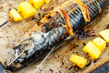 Grilled mackerel on a skewer with tropical pineapple pieces.の写真素材