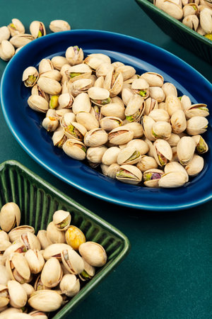 Salted pistachio nuts in shells, tasty snack and food background.