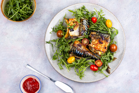 Baked mackerel fillets paired with fresh greens and cherry tomatoes. Place for recipe. Food photography.の写真素材