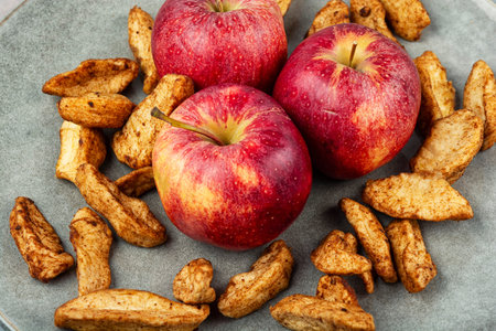 Soft dried apple slices without skin, sprinkled with warming spices. Delicious winter snack ready to enjoy anytime.の写真素材
