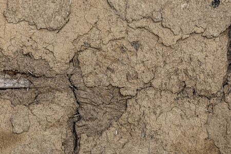 Old destroyed clay wall of a half-timbered house with cracks, texture, background