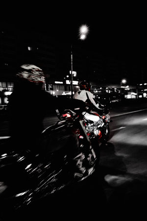 Motorcyclist biker riding in the city at night. Motion Blurの写真素材