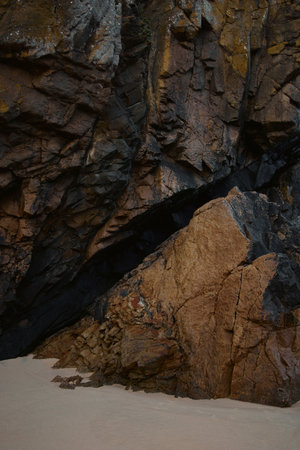 Coastal rock formation, mountain and sand