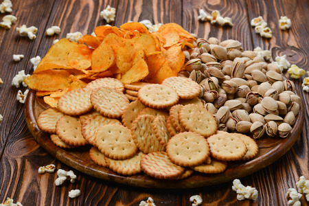 Snacks on a wooden background. Space for text or design.の写真素材