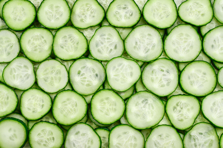 Fresh green slices of cucumber as backgroundの写真素材