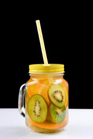 Infused water with kiwi and orange in jarsの写真素材