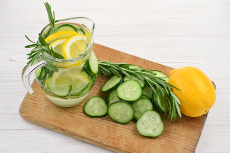 Cold and refreshing detox water with lemon, cucumber, rosemary and ice in glass jar. Copyspace. Bannerの写真素材