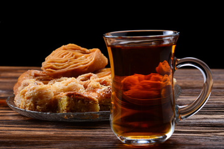 Turkish sweet baklava on plate with Turkish tea. 