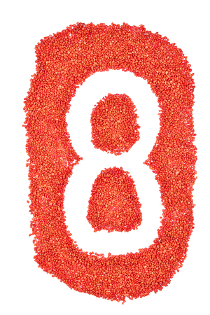 Number 8 made by on orange sand isolated on a white backgroundの写真素材