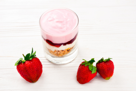 Home made granola breakfast with strawberries and plain yogurt, served in the glass.の写真素材