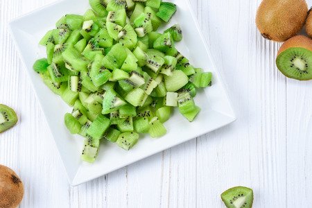 Freshly sliced kiwi fruit with whole kiwis in background. の写真素材