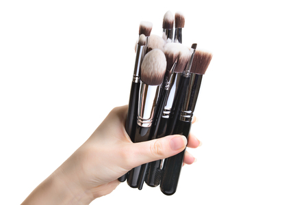 Professional make-up brush cosmetic in female hand beautician isolated on white backgroundの写真素材