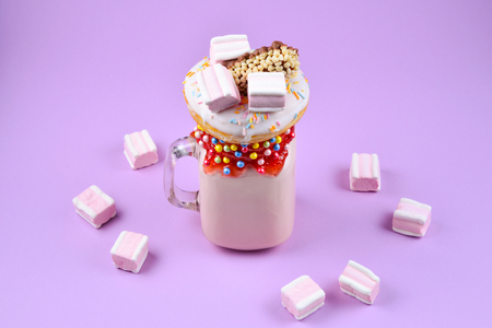 Pink strawberry freakshake with marshmallow and sweets.の写真素材