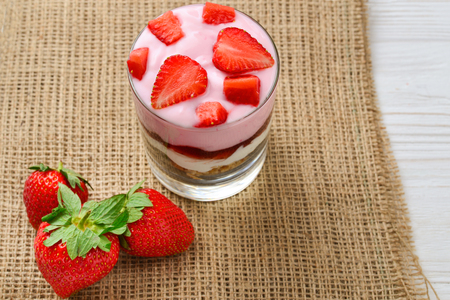 Home made granola breakfast with strawberries and plain yogurt, served in the glass.の写真素材