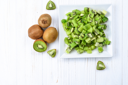 Freshly sliced kiwi fruit with whole kiwis in background. の写真素材