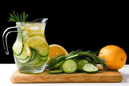 Cold and refreshing detox water with lemon, cucumber, rosemary and ice in glass jar. Copyspace. Bannerの写真素材
