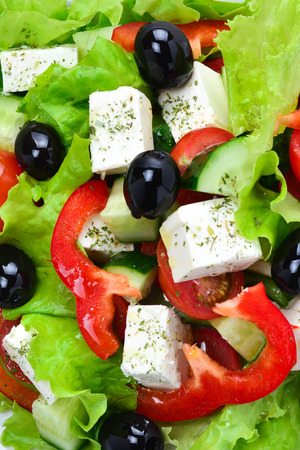Greek salad on a white wooden background. Space for text or designの写真素材