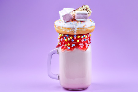Pink strawberry freakshake with marshmallow and sweets.の写真素材