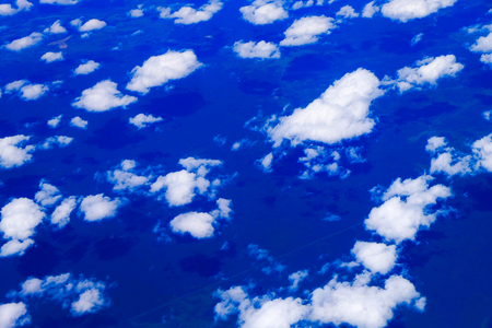 Blue sky high view from airplane clouds shapes. Sky background.の写真素材