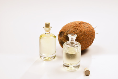 Natural coconut oil in bottles on white background.の写真素材