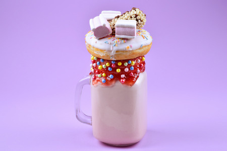 Pink strawberry freakshake with marshmallow and sweets.の写真素材