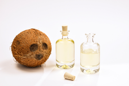 Natural coconut oil in bottles on white background.の写真素材