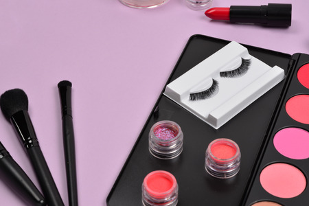 Professional makeup products with cosmetic beauty products, blushes, eye liner, eye lashes, brushes and tools.の写真素材