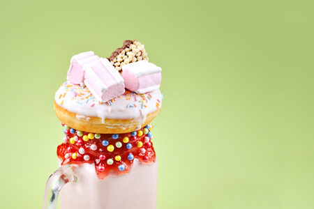 Pink strawberry freakshake with marshmallow and sweets.の写真素材