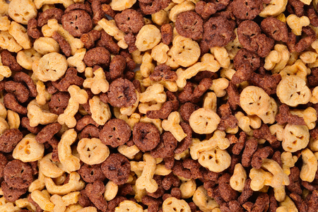 Chocolate flakes in the form of skulls and bones background. Top view.の写真素材