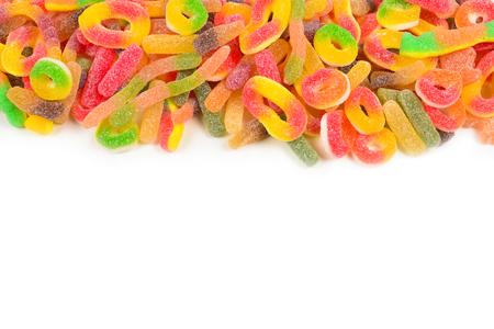 Frame of assorted gummy candies isolated on white. Top view. Space for text or design.の写真素材