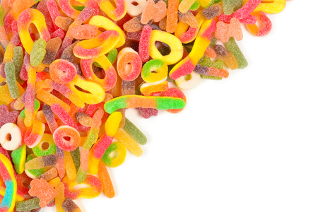 Frame of assorted gummy candies isolated on white. Top view. Space for text or design.の写真素材