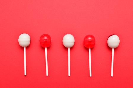 Lollipop on a red background. Space for text or design.の写真素材