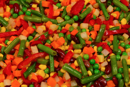 Sliced vegetables, corn, beans, peas, carrots, sweet peppers background.の写真素材