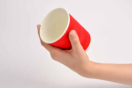 Woman and holding paper cup for vaious drinks isolated on white.の写真素材