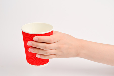 Woman and holding paper cup for vaious drinks isolated on white.の写真素材