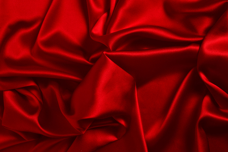 Red silk or satin luxury fabric texture can use as abstract background. Top view.の写真素材