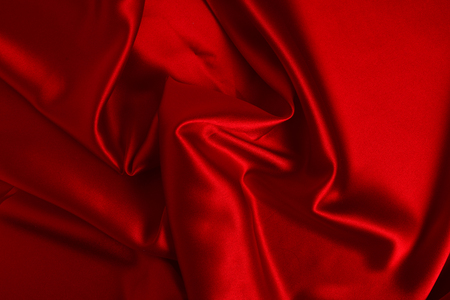 Red silk or satin luxury fabric texture can use as abstract background. Top view.の写真素材